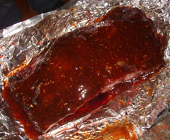 Sauced portion of beef brisket before wrapping