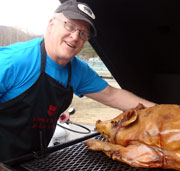 Terence Lernihan poses with a roasting pig