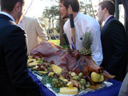 Fraternity alumni carry the pig